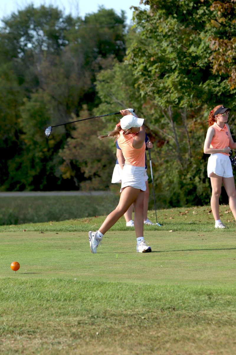 Hitting the ball, senior Sophia Rossi hits her driver at the tee box. On Sept. 18, the Varsity Fenton girls golf team faced Goodrich and lost.