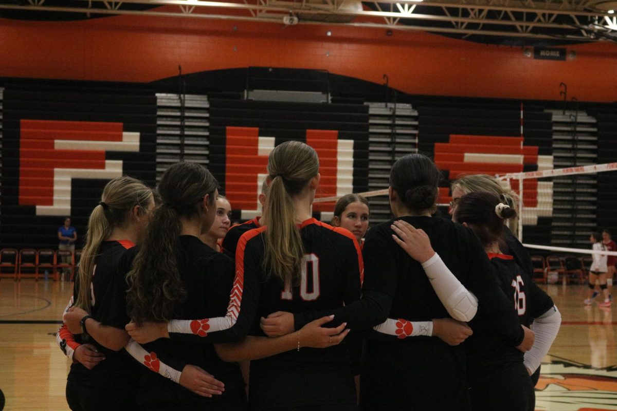 Circling up, the JV girls volleyball team are huddling in the time out. On Sept. 9, the Fenton JV girls volleyball team played Holly and won all three sets. 