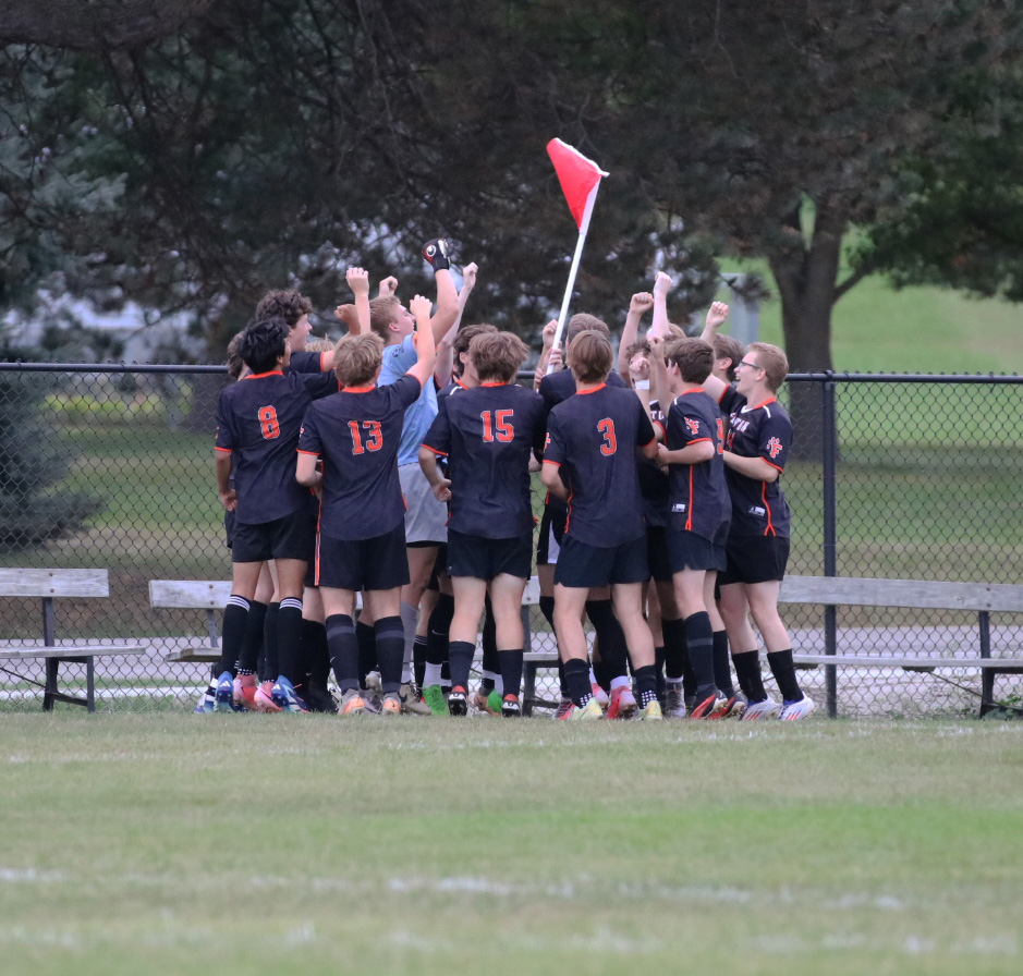 Cheering, the Tigers hype themselves up before the game. On Sept. 26, the boys varsity soccer team went up against Clio High winning 3-1.  