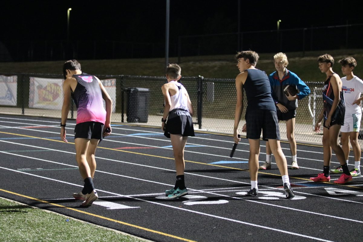 Preparing to run, the boys cross country team competes in all the track relays. On Sept. 26, the cross country team spent the night on the football field for ball run the next day. 