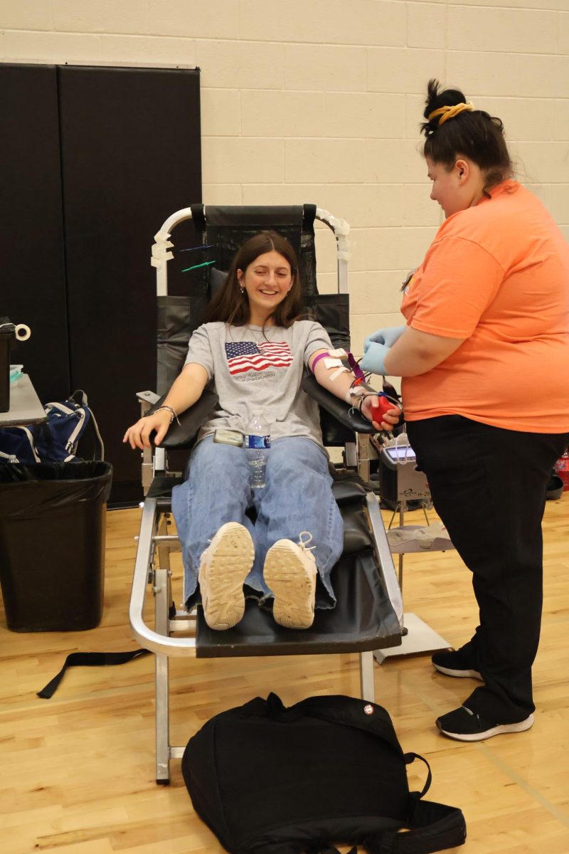 Preparing to give blood, senior Paige Harrison donates her blood to save lives. On Sept. 6, NHS held its first blood drive of the year.