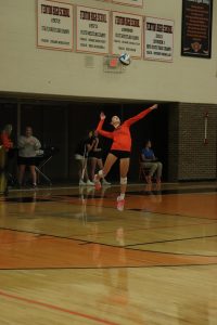 Winding up, sophomore Katheryn Hunt is serving the ball. On Sept. 9 the Fenton JV volleyball team played against Holly and won all three sets. 