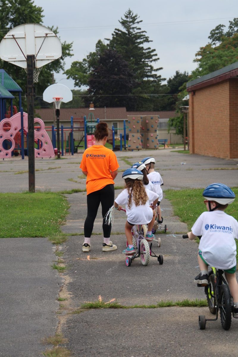 Volunteering her time, sophomore Jessie Livingston helps the kids to learn road safety. On Aug. 8, the Kiwanis club helped to run safety towns. 