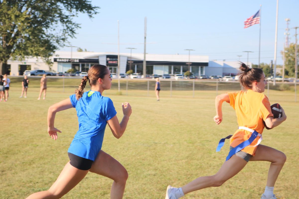 Running, Seniors Laila Blackwell and molly dixon play football at the powder puff practice. Fenton held a powder puff practice on Sept. 17.