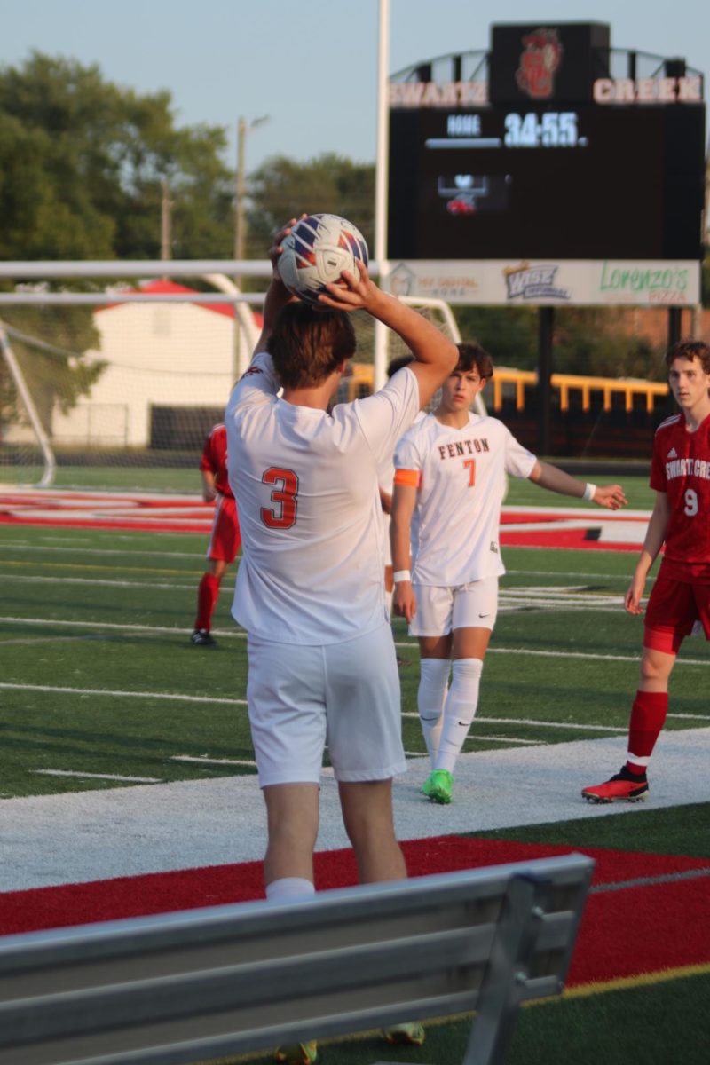 Throwing the ball, junior Dane Mckee puts the ball in play. On Sept. 4, the Fenton varsity soccer team went up against Swartz Creek taking the win 4-1. 