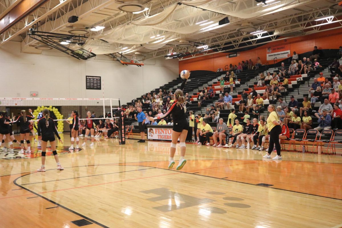 Jumping, sophomore Maryn Teddy serves the ball to Linden. On Sept. 18, the JV volleyball team played against Linden and won the match.