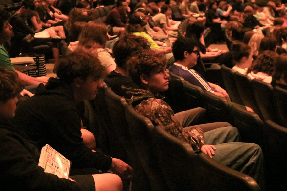 Sitting, freshman Collin Barnes listens to his first class meeting. On Sept. 5, all freshman reported to the Ruby Zima auditorium to learn information about the upcoming school year. 