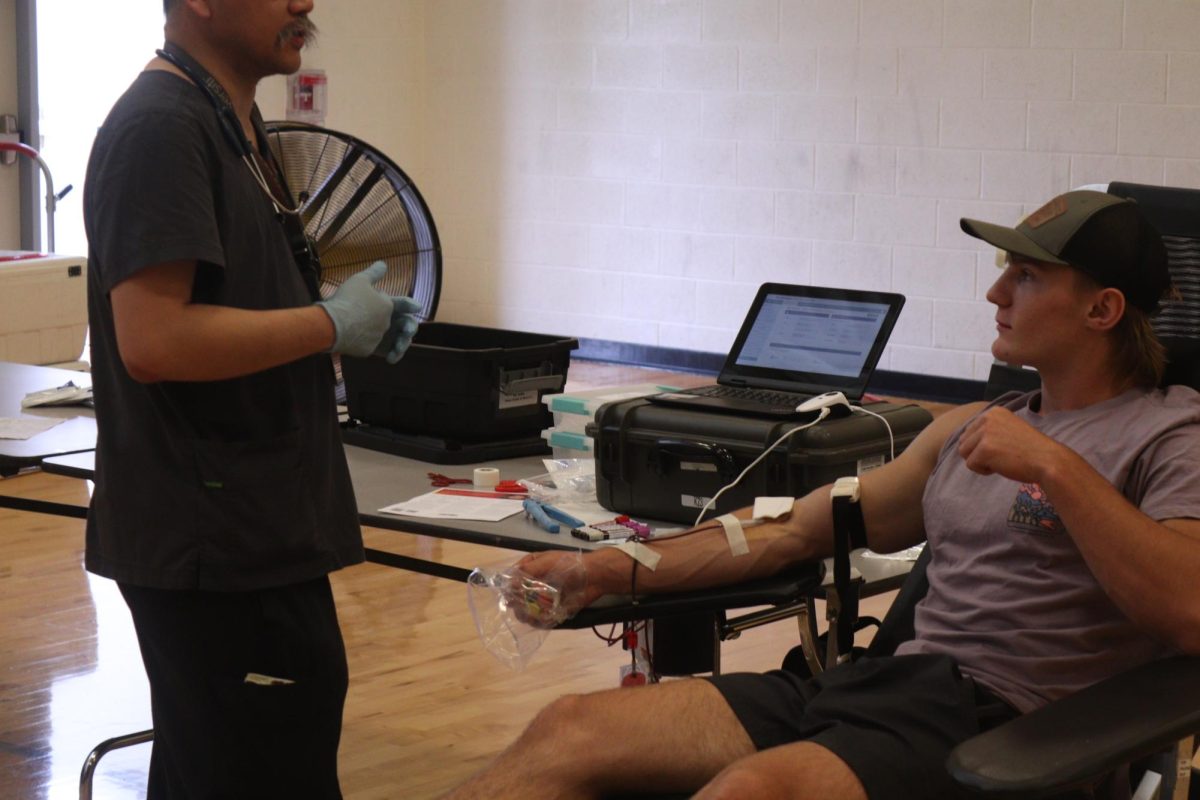 Giving blood, junior Kaden Keys sits as he donates blood for the blood drive. On Sept. 6, Keys joined many others to give blood during the NHS blood drive.