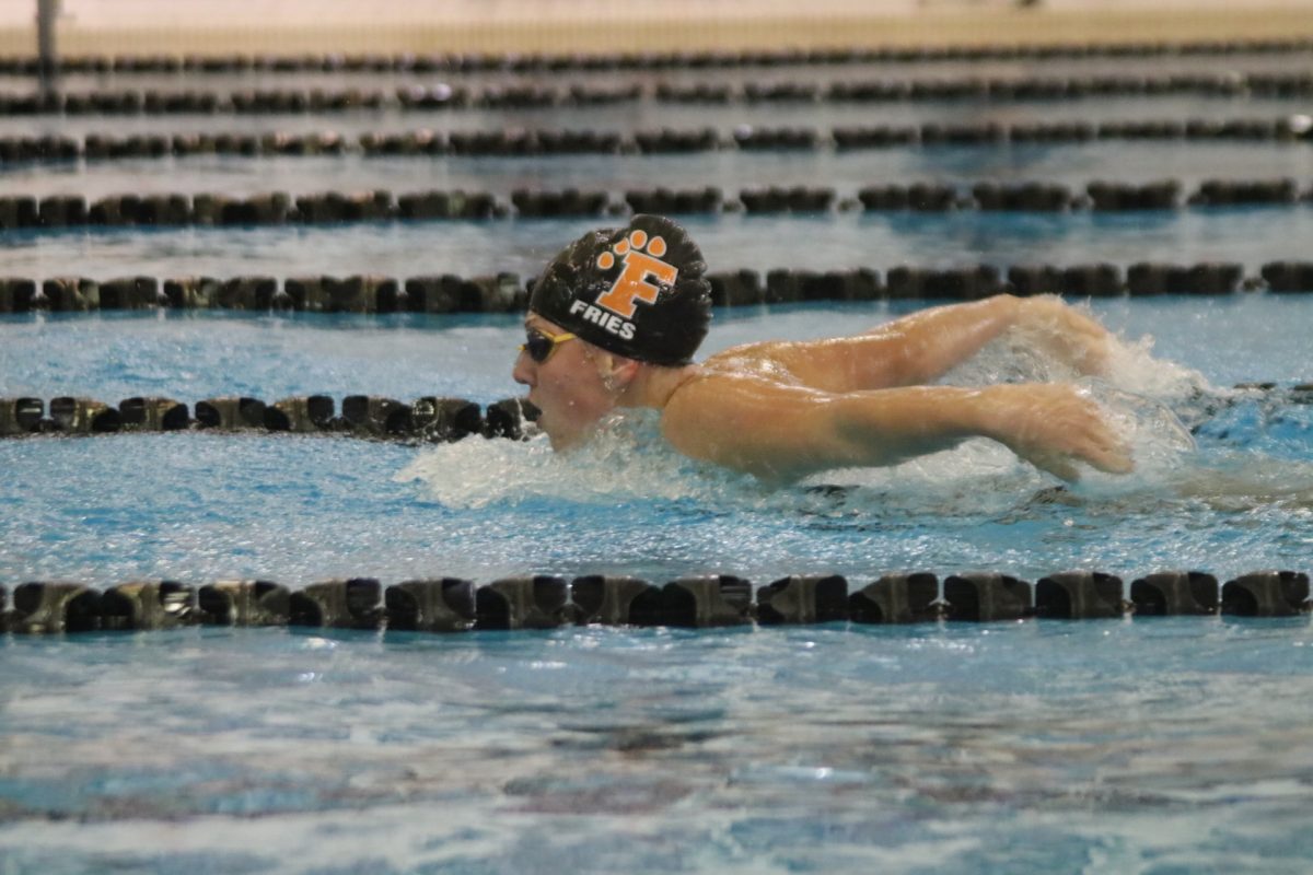 Swimming, Josie Fries is rushing to the end of her lane doing the butterfly stroke. On Sept. 5 Fries helped the FHS swim team win against Kearsley.