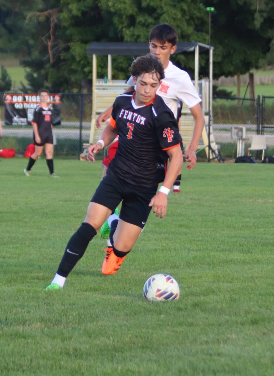 Watching the ball, junior Dillon Hamilton advances up the field. On Sept. 9, the Tigers went up against Holly High winning 3-1. 