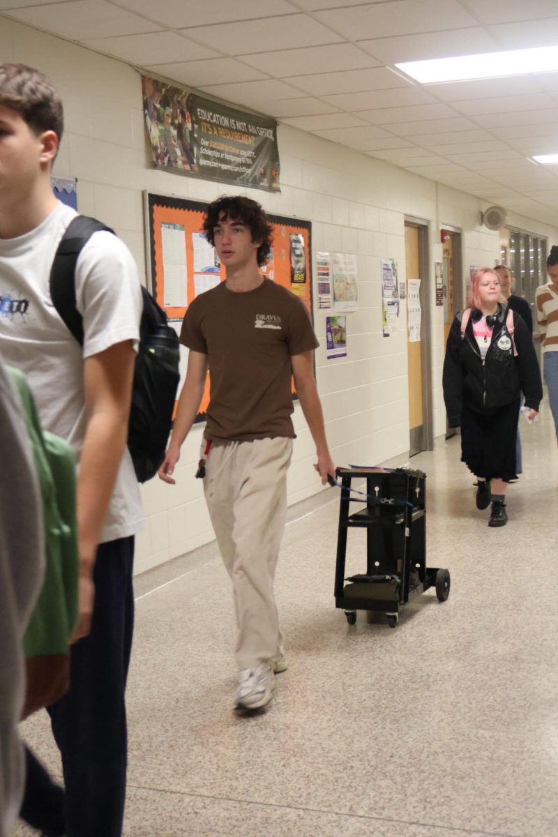 Walking, junior Owen Baize participates in spirit week. On Sept. 25, FHS had anything but a backpack day. 