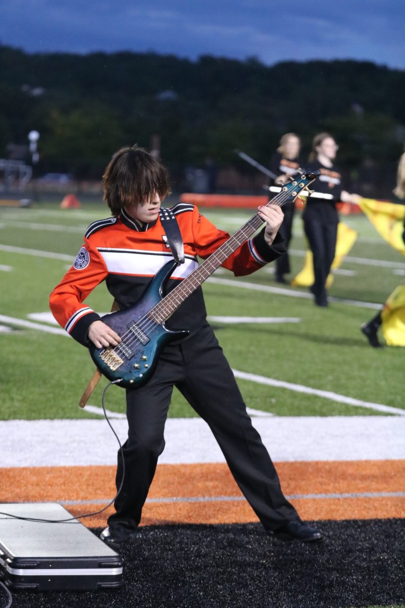 Looking, sophomore Joe Pedwaydon played bass at a football game. On Sept. 6, the FHS marching band performed at halftime.