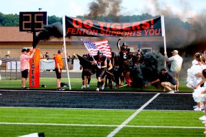 Running, senior Cameron Scheneman leads the charge onto the field. On Aug. 28, Fenton varsity football went up against Dow High school, winning 28-14.