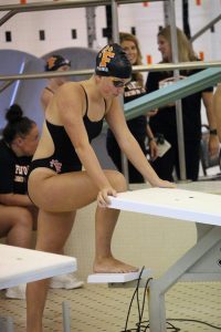 Standing, junior Josie Fries prepares to swim in her event. On Sept. 5, Fenton's Swim and Dive team competed against Lake Fenton and Kearsley.