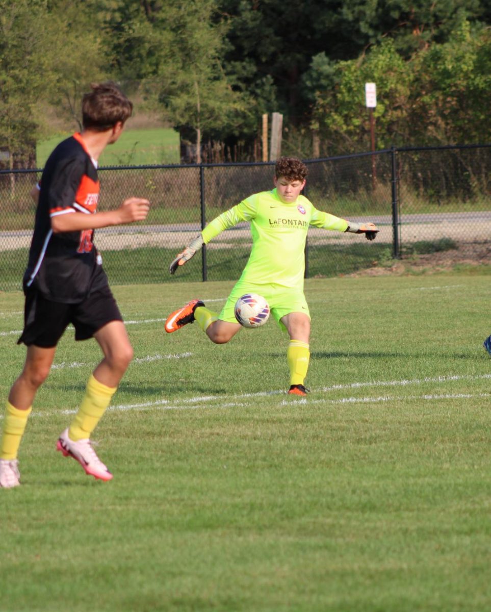 Punting, sophomore Grayson Tersigni attempts to kick the ball up the field. On Sept. 11 the JV soccer team played Owasso winning 6-1.