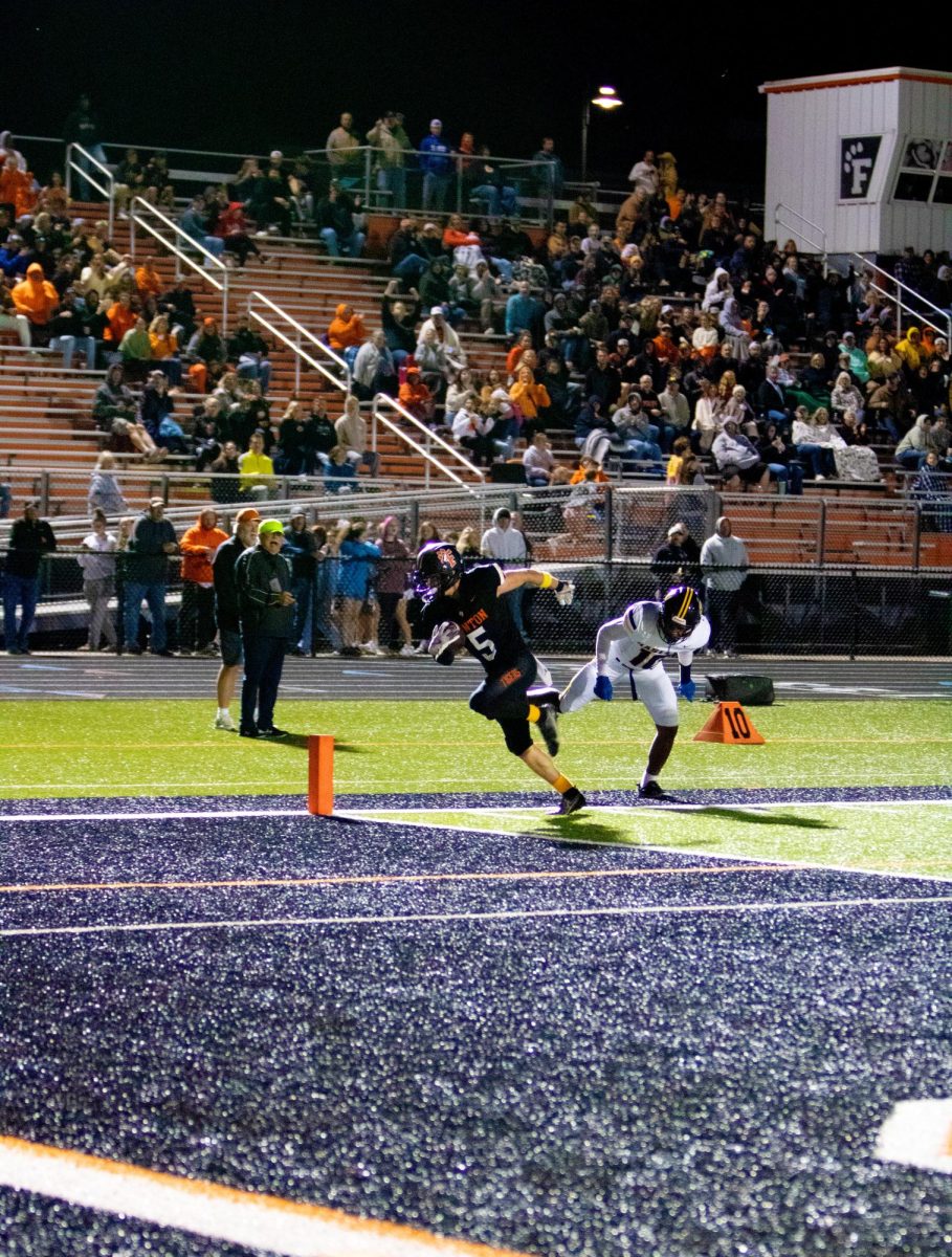 Running, junior Luke Dotson sprints into the endzone. On Sept. 6, Fenton varsity football went up against Haslett winning 21-14