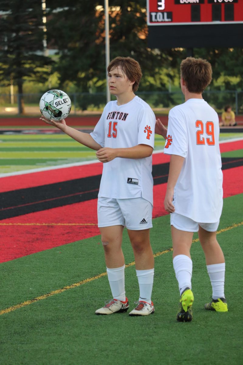 Looking for a teammate, senior Ian Elsholz prepares to throw the ball back into the game. On Sept. 25, the Fenton varsity soccer team played the Linden Eagles. 