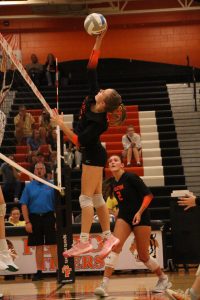 Hitting the ball, junior Marley Pihlstrom plays in a game. On Sept. 18, Varsity Volleyball competed against Linden and won 3-0. 