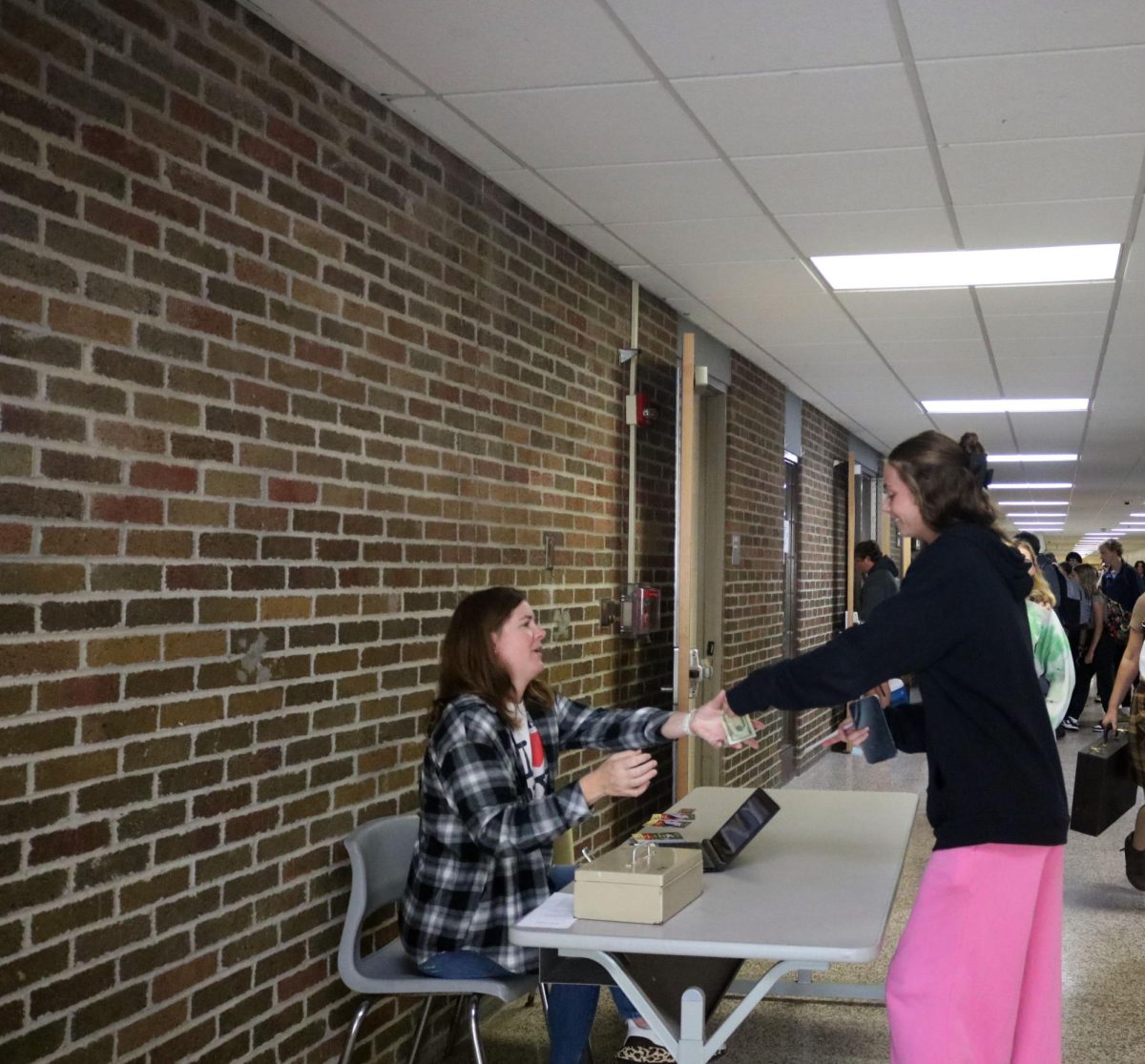 Purchasing her homecoming ticket, senior Adrianna Ayre prepares for the upcoming dance.  On Sept. 28 Fenton hosted their yearly homecoming.   