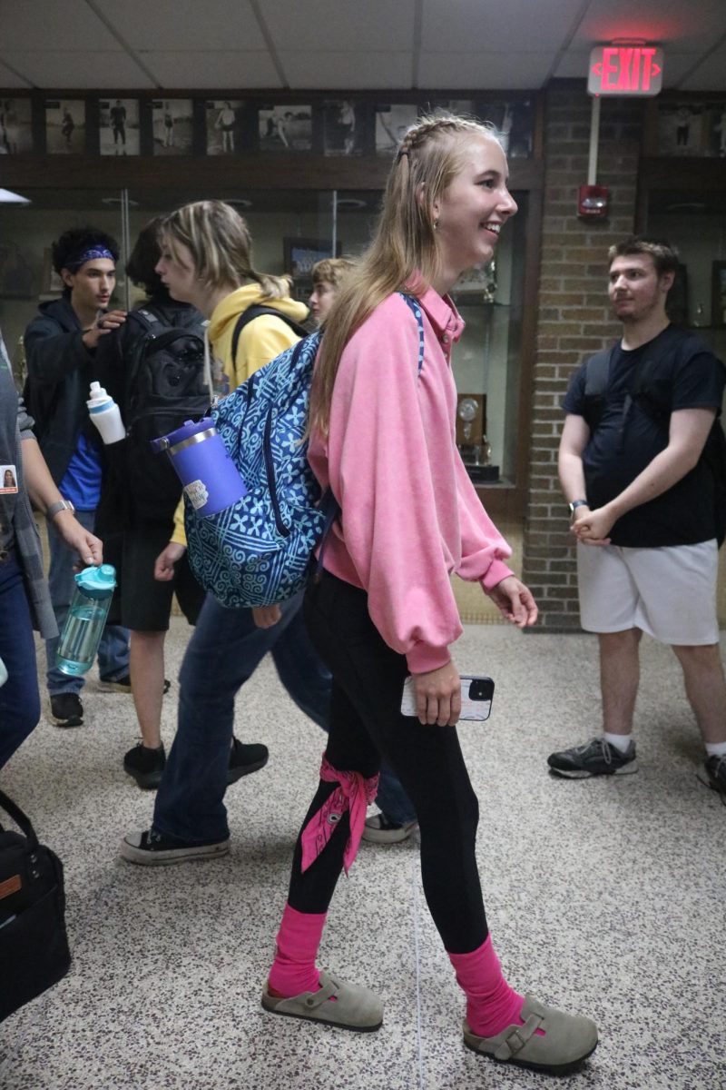 Walking, junior Cassandra Harris wears pink to represent juniors. On Sept. 26th, students participated in colors wars for homecoming spirit week.