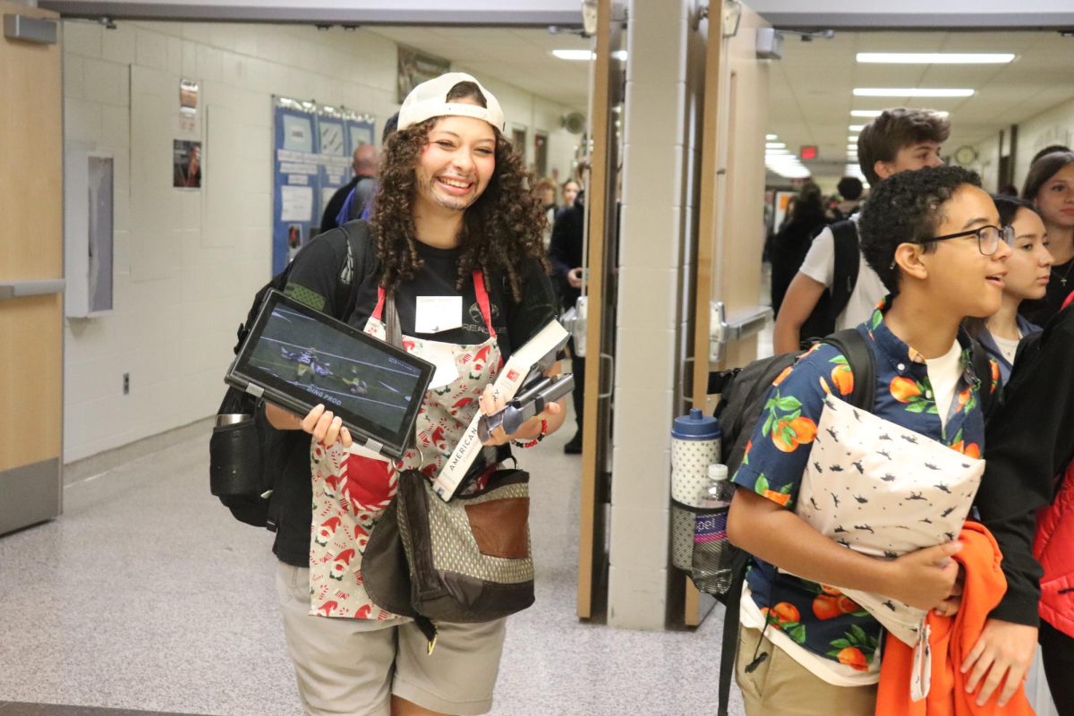 Smiling, sophomore Elyse Morgan dresses up as a barbecue dad. On Sept. 24 Fenton students dressed up to show their tiger spirit. 