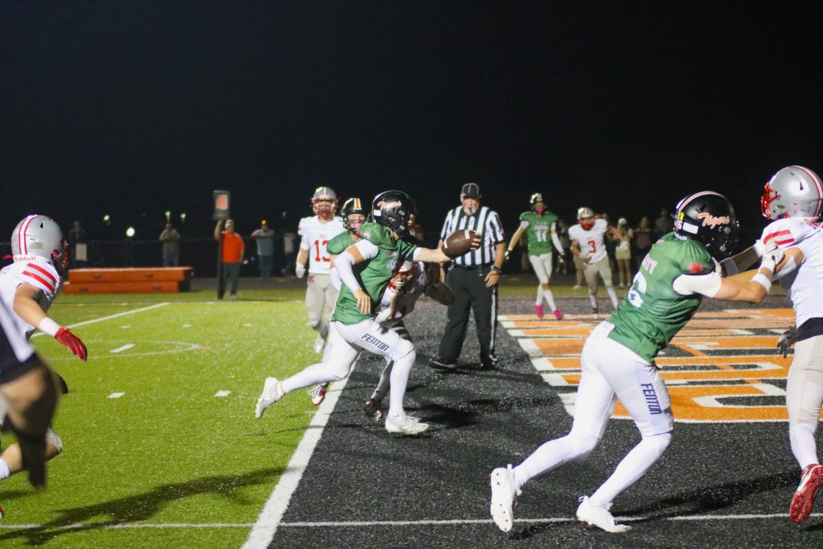 Running, senior Noah Sheil rushes into the endzone. On Sept. 20, Fenton varsity football went up against Holly winning the game.