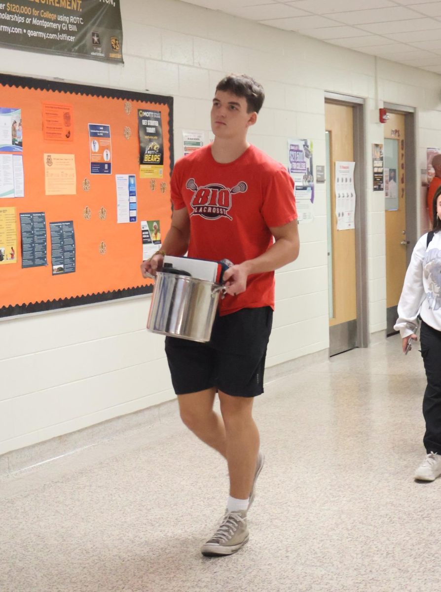 Walking through the hallway, senior Lucas Hamlin carries a kitchen pot. On Sept. 25, FHS held anything but a backpack day for homecoming spirit week.