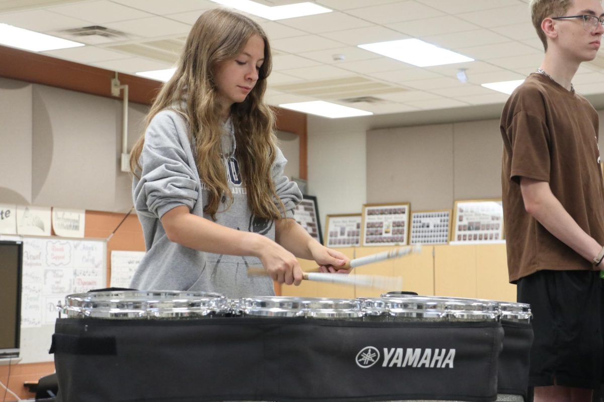 Drumming, junior Peyton Thorp plays the tenor. On July 10th, the Fenton drumline held a practice in the choir room. 