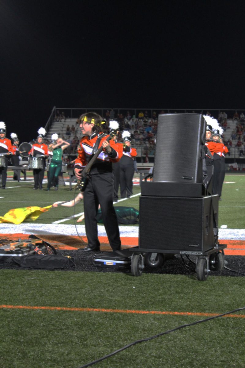 Rocking out,Sophmore Joe Pedwaydon playing bass in the Varsity Football halftime show.