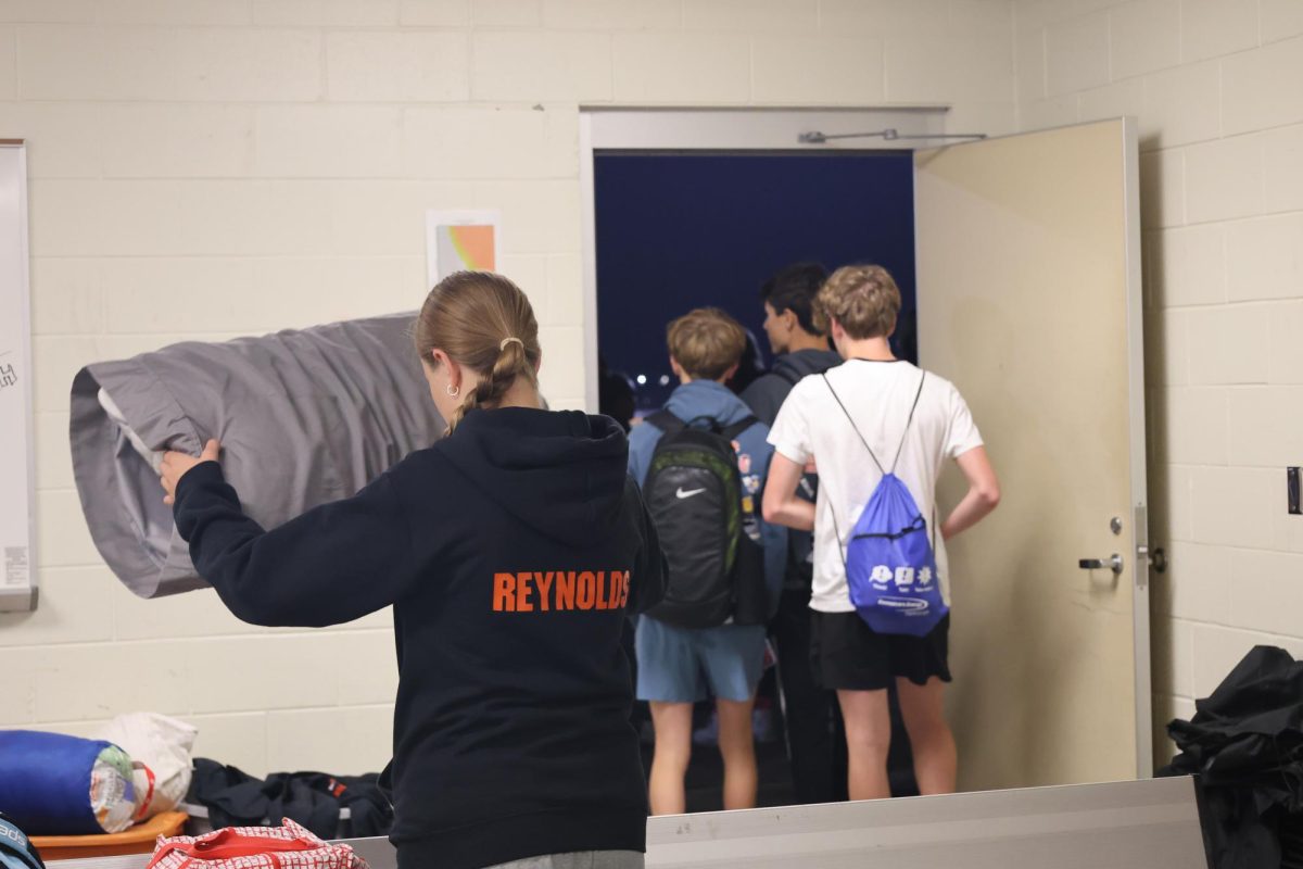 Walking out, The fenton cross country team leaves the team room to go eat pancakes. On sept. 26th The cross country team stayed overnight at the football field.