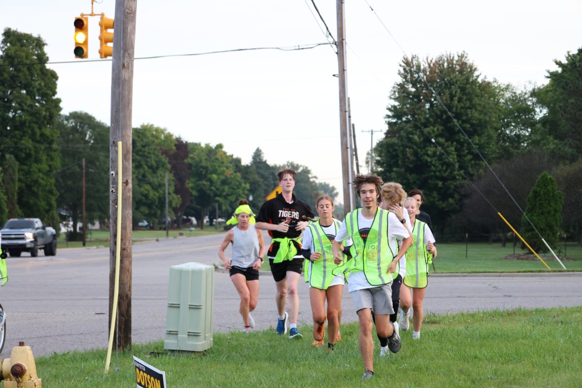 Smiling, senior Ben Bishop and the Fenton cross country ran the football. On sept. 27th The cross country team ran the football from kursley.