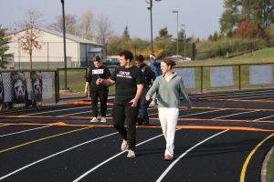 Walking, senior Chris Dobek and junior Laynie Barz participate in a fundraiser. On Oct. 30, students were given an option to walk in an Alzheimer's walk lead by senior Addison Dolliver.