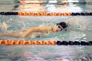 Swimming, junior Laynie Barz competes in the 500 freestyle to try to try to qualify for MISCA meet. On Oct. 1, The FHS girls varsity swim team swam against Midland Dow and lost by 10 points.