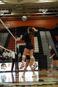 Jumping to the ball, senior Megan Gornick hits the ball. On Oct. 9, varsity volleyball competed against Kearsley and won all three sets. 