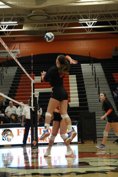 Jumping to the ball, senior Megan Gornick hits the ball. On Oct. 9, varsity volleyball competed against Kearsley and won all three sets. 