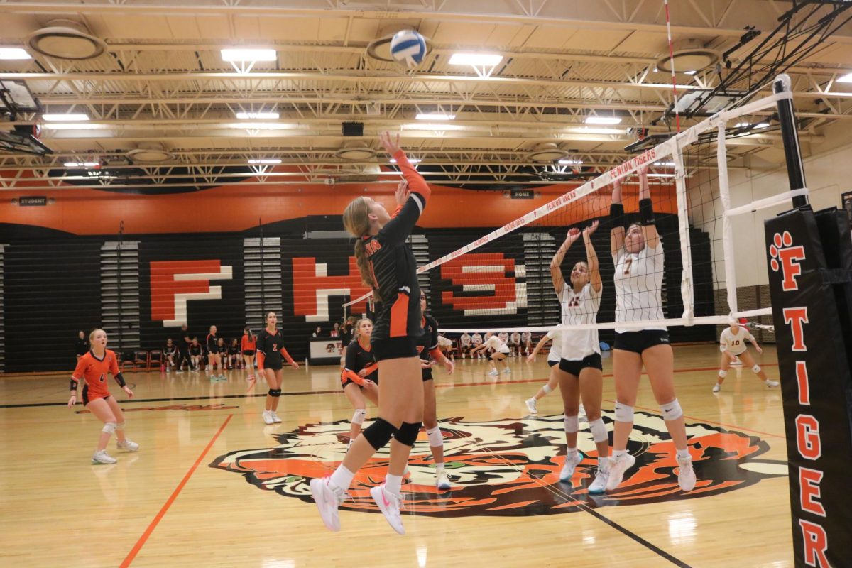 Jumping up, sophomore Lucy Weber prepares to tip the ball to flushings side. On Oct, 16 the JV volleyball team played Flushing and left with a win of 2-1.