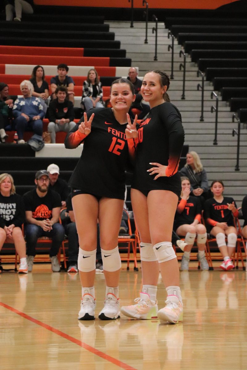 Posing, seniors Anna Logan and Abby Gonzales get their picture taken during senior night. On Oct. 9, the varsity volleyball team beat Kearsley in all three matches.