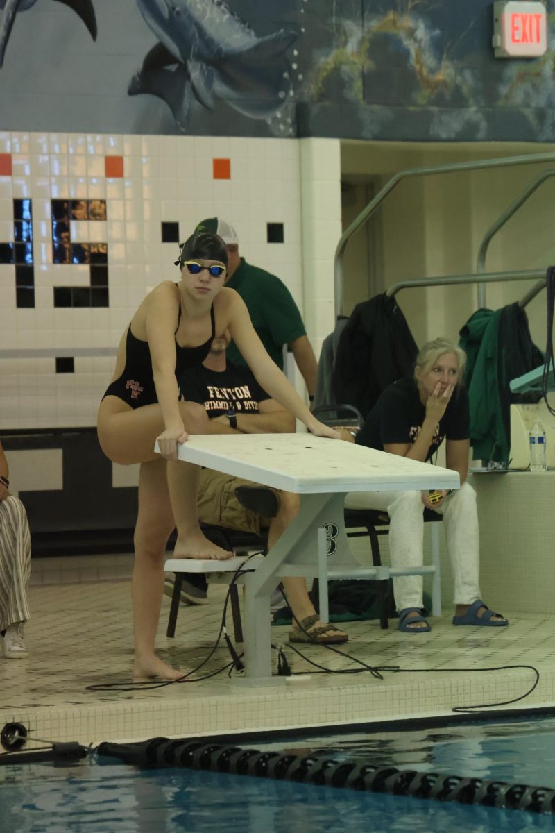 Standing, Senior Laynie Barz prepares to swim 500 free. On Oct. 1, the FHS swim and dive team competed against Dow.