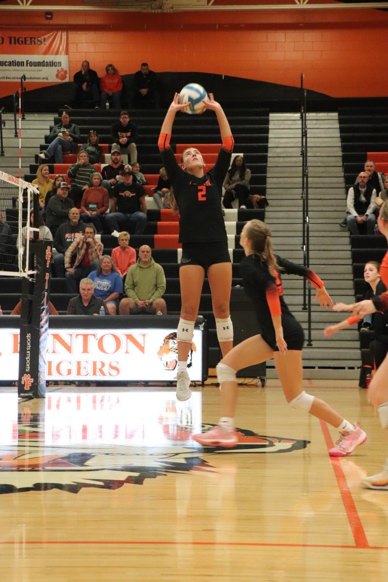 Eyes on the ball, junior Eva Long sets up her teammate. On Oct. 16, the varsity volleyball team played Flushing and beat them, winning three out of four sets.