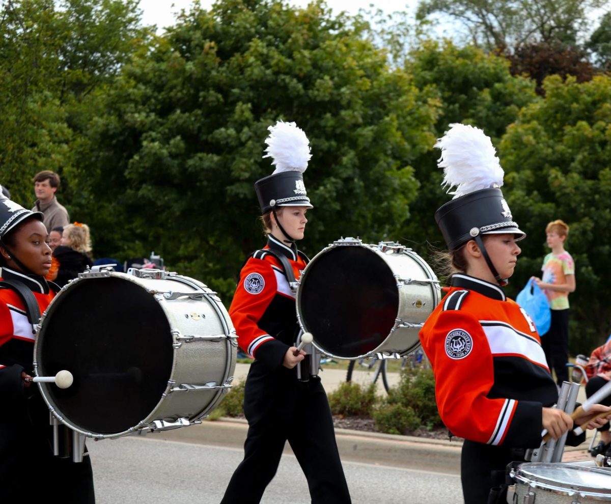 Marching, junior Haven Selby participates in the Fenton Homecoming Parade. On Sept. 27, the Fenton Marching Tigers 