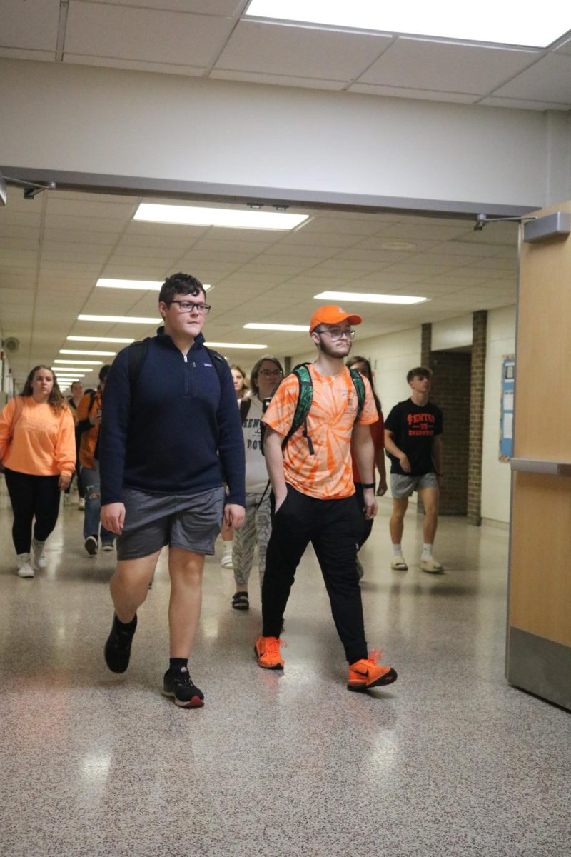 Walking, senior Thomas Andersen wears orange and black. On Sept. 27, the Fenton High held their last homecoming spirit day.