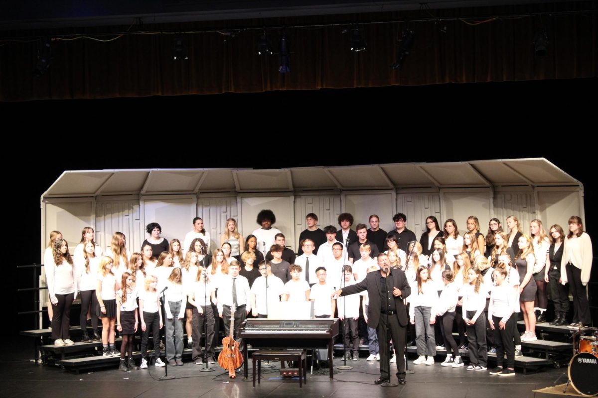 Introducing, teacher Brad Wright brings out his 7th,8th, and Bella varsity, choirs with a surprise visit from the ambassadors  to perform a song. On Oct 24 the Ruby Zima auditorium held a choir concert to show off what they have worked on so far this year.