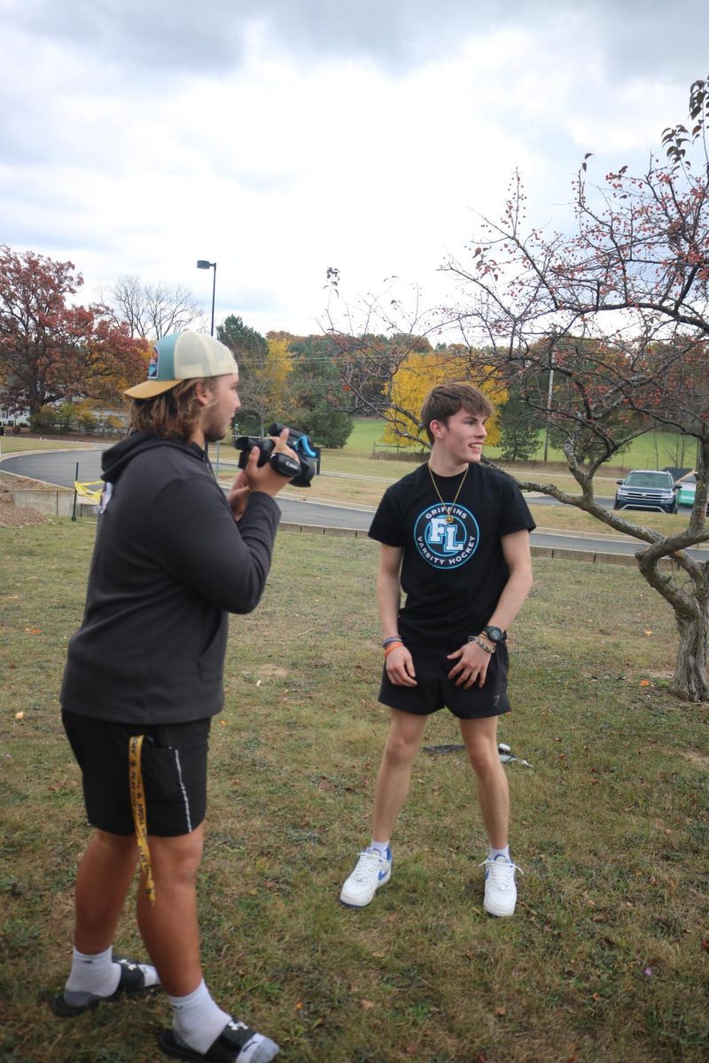 Posing, sophomore Hunter Anderson and senior Tyler Rockman shoot a scene. On Oct. 23, Mr. Smith's Video 1 class recorded a video for a spooky short film.