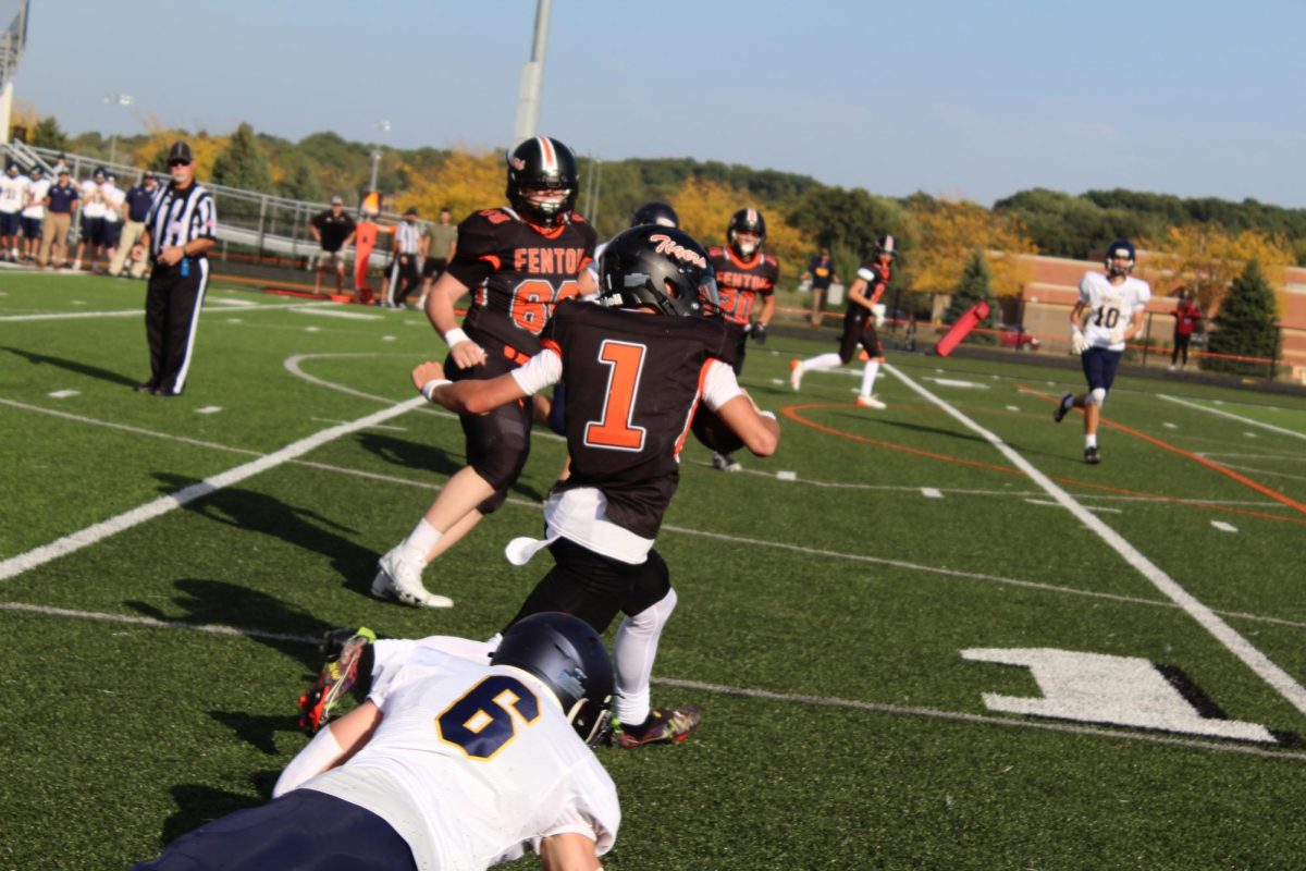 Sprinting, Freshman Alec Mock pushes through to get the ball across the field, On Oct 3 Fenton Lost (12-14) against Dewitt.