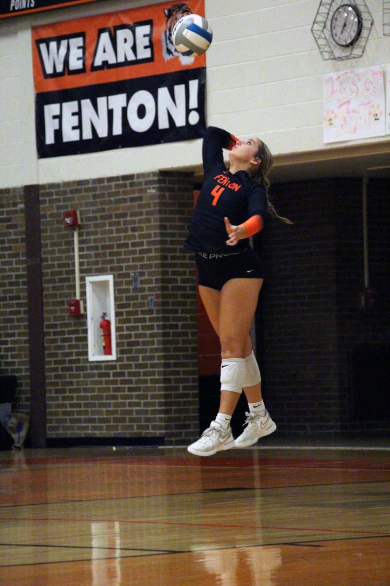 Serving, senior Shyanna Baker hits the ball. On Sept. 30, Fenton varsity volleyball competed against Swartz Creek and won 3-0. 