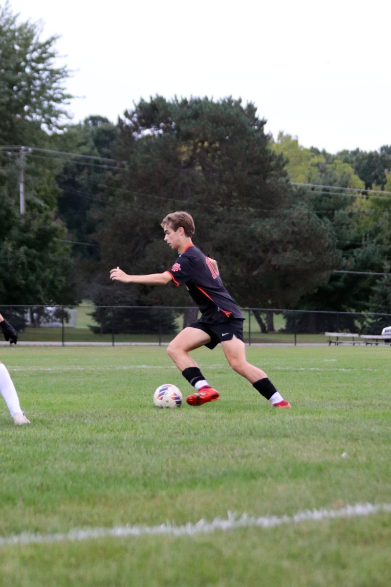 Watching the field, senior Jack Oberle moves the ball. On Sept. 26, FHS soccer team played the Clio trojans and won 4-0.