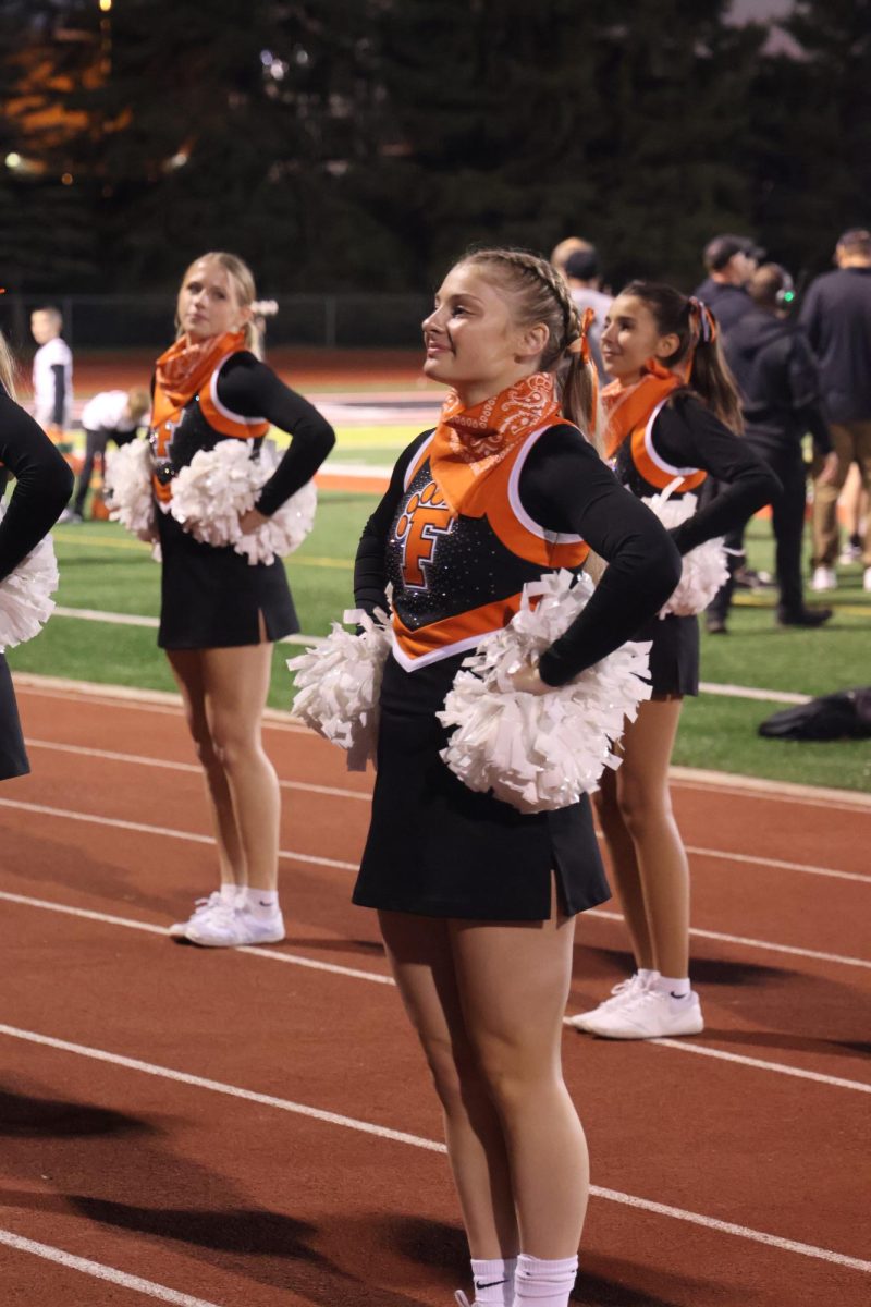 Smiling, junior Evie Metcalfe faces the student section. On Oct. 4, Fenton beat Linden 24-21.