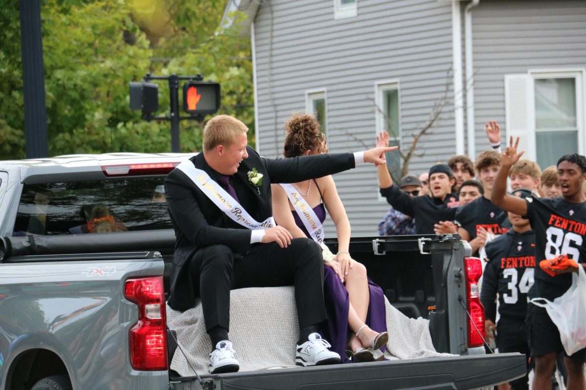 Smiling, sophomore Cooper Ford and Jessie Livingston celebrate being crowned for their class. On Sept. 27, Fenton held a parade downtown to celebrate homecoming.