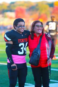 Smiling, senior Mario Anthony Yap celebrates with his mother. On Oct. 20, Senior Night is held at Fenton High Schools football field. 