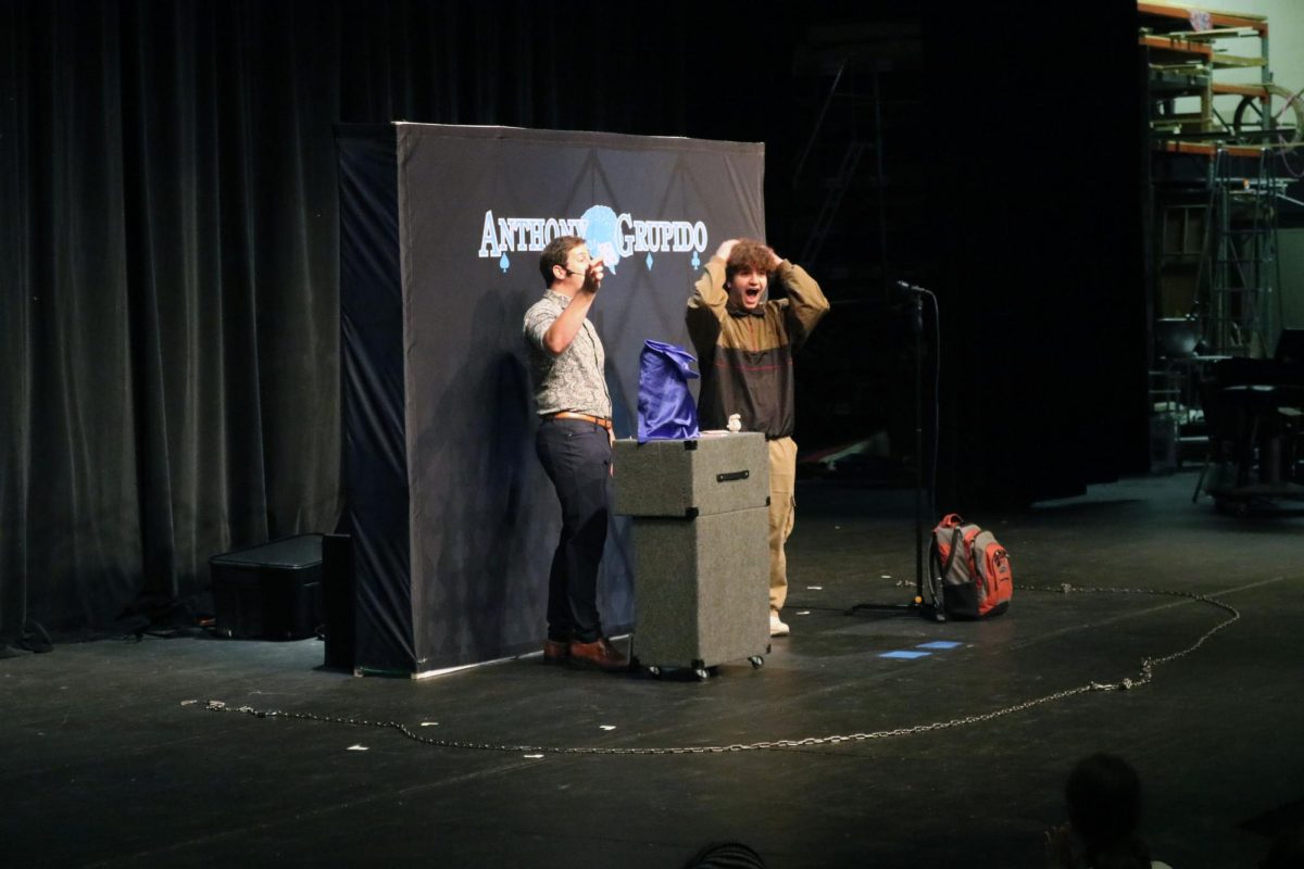 Participating, sophomore Hudson Dyer volunteers himself for a magic trick.  On Oct. 17, sophomores and freshman attended an assembly about mental health. 